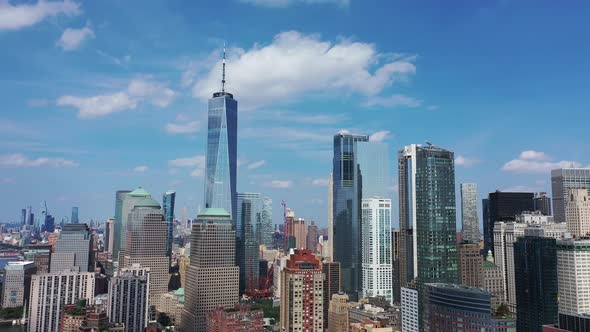 An aerial view of lower Manhattan. The drone trucks left while panning right. The freedom tower is t