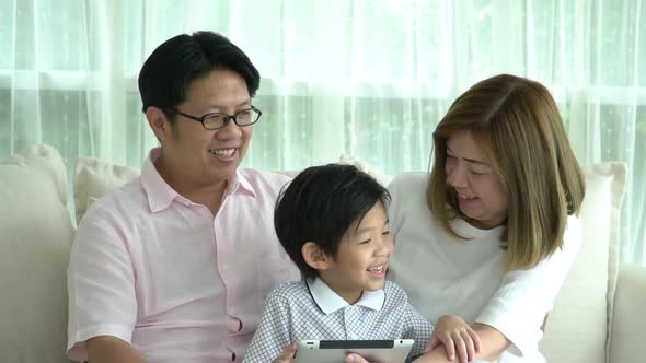 Asian Family Using Tablet At Home