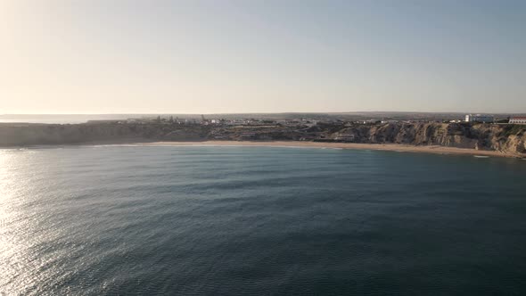 Slow moving drone flying over a calm Atlantic ocean in Sagres Portugal.