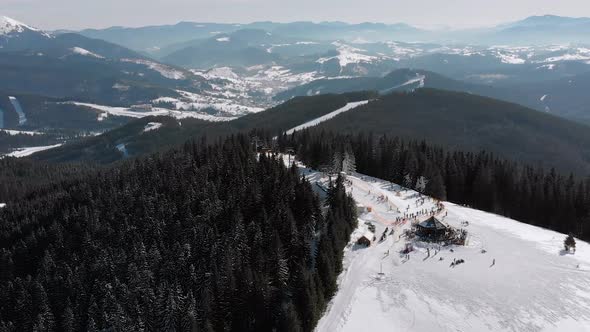 Aerial Ski Slopes with Skiers and Ski Lifts on Ski Resort. Snowy Mountain Forest