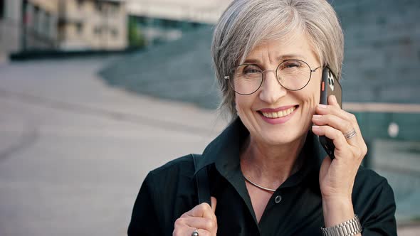 Closeup Portrait of Happy Grayhaired Mature Woman with Smartphone