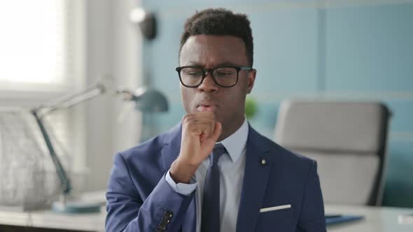 Portrait of Sick African Businessman Coughing