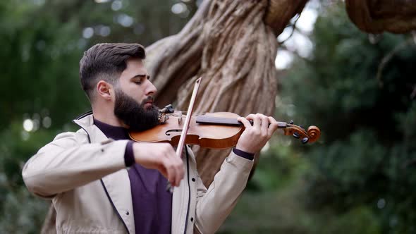 Concert of Violinist on Forest Handsome Man is Playing Fiddle Portrait Shot of Musician