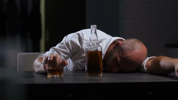 Alcoholic Wasted Man Sleeping Drunk on the Table