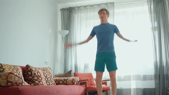 Strong Muscular Man in Sportswear Doing Exercises at Home