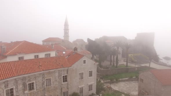 Red Roofs of the Old Town of Budva in Dense Fog