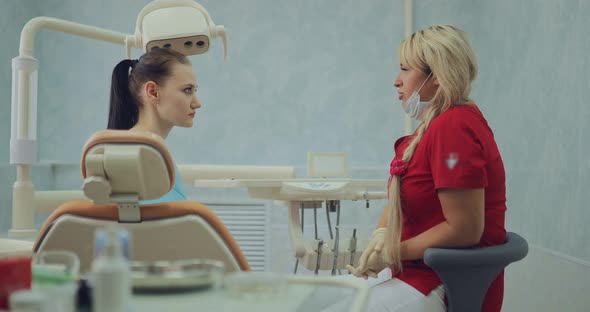 Pretty Female Doctor Talks to the Patient About Further Procedures
