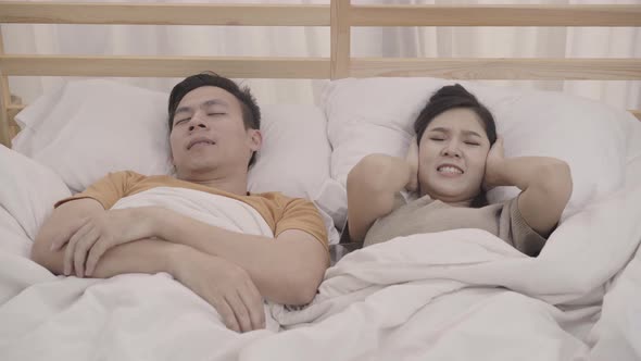 Asian couple wife annoyed Snore's husband when their sleep female insomnia and can't sleep.