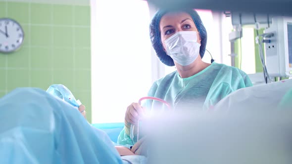 Surgeon Woman Performs Surgery on Patient