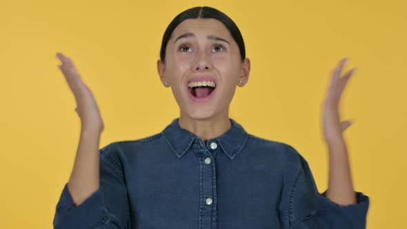 Latin Woman Shouting, Screaming, Yellow Background 