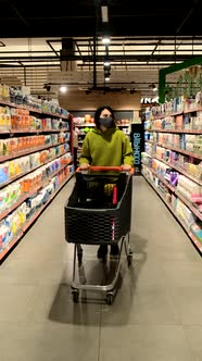 Woman in Medical Mask Passing Walking By Groceries Store with Medical Mask