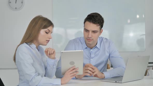 Female Business Colleague Demonstrating New Plan on Tablet