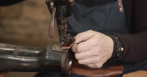 Craftsman Working with Leather in a Workshop