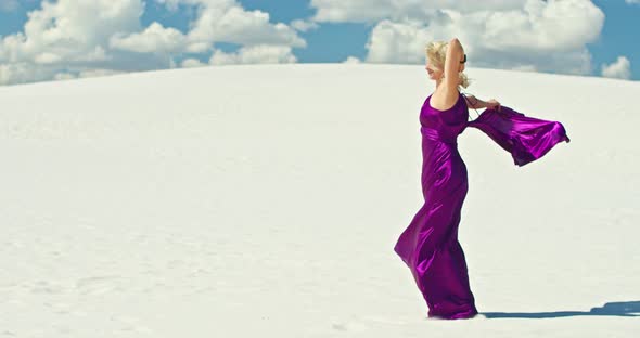 Cinematic Slow Motion of a Woman Walking on a Sand Dune