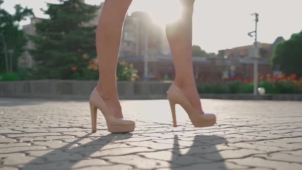 Closeup Unrecognizable Sexy Female Feet in High Heels Walking Along City Street