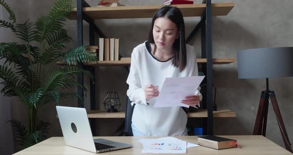 Young Asian Business Woman Working with Laptop and Papers Busy Woman Paying Bills Online Banking