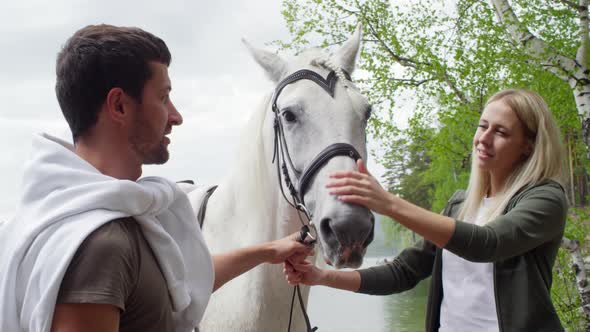 Couple Bonding with White Horse