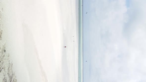 Vertical Video Kitesurfing Near the Shore of Zanzibar Tanzania Aerial View