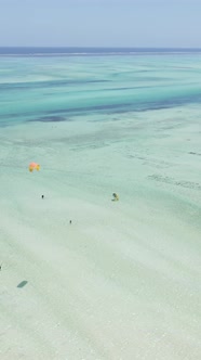 Vertical Video Kitesurfing Near the Shore of Zanzibar Tanzania