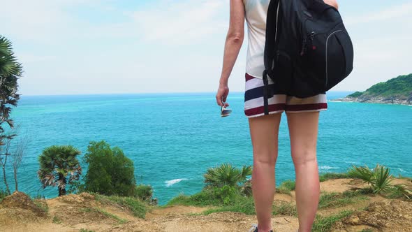 Feet of A Tourist Girl Traveling Through a Tropical Country with A Backpack