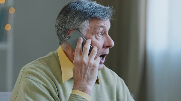 Caucasian Old Greyhaired Man Grandfather at Home Talking on Mobile Phone Remote Conversation Distant