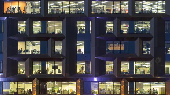 View of office windows with working people