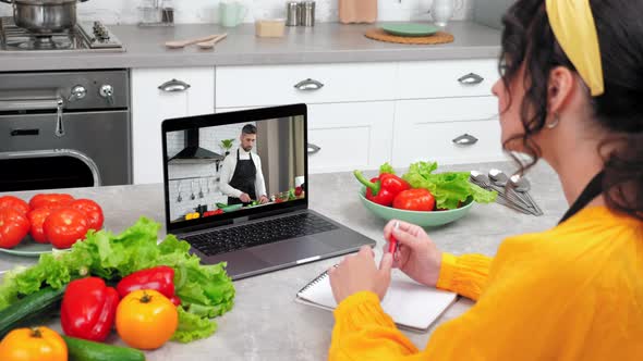 Woman in Home Kitchen Study Online Video Call Webcam Laptop Tells Teacher Chef