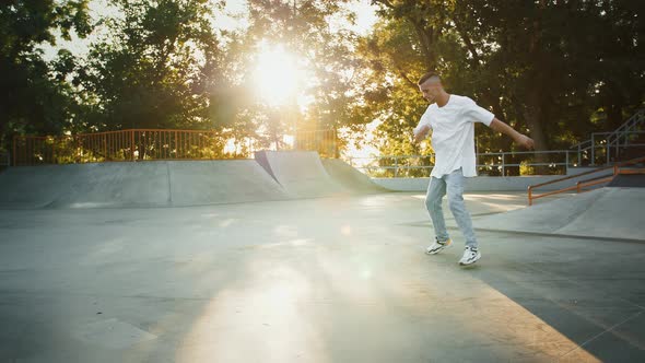 Young Male is Spinning Performing Windmill Movement While Breakdancing on Pump Track of Rollerdrome