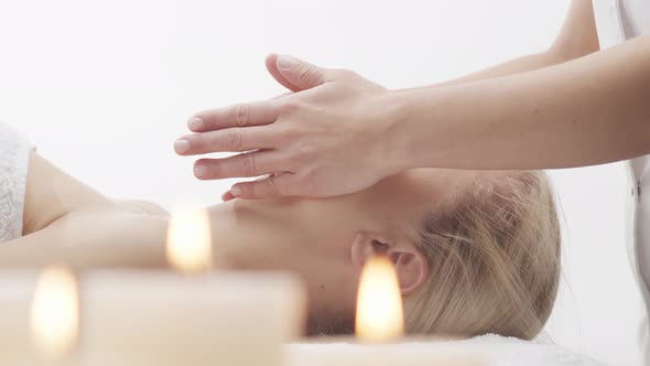 Young, healthy and beautiful woman gets massage therapy in the spa salon.