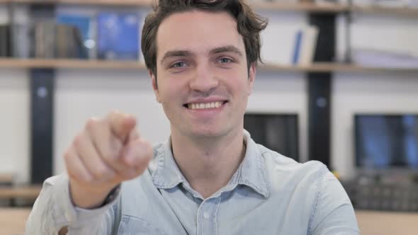 Man Pointing Toward Camera