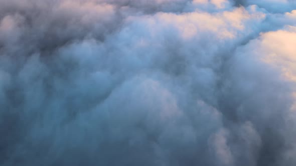 Reveal Footage of Aerial View From Above at High Altitude of Dense Puffy Cumulus Clouds Flying in