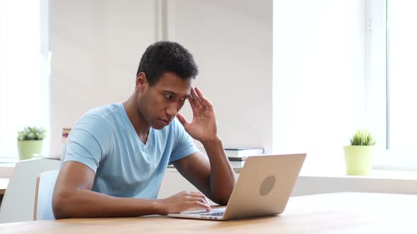 Tired Young Black Man Working on Laptop