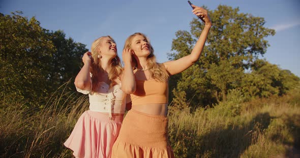 Two Blondes Take Pictures of Themselves in Nature