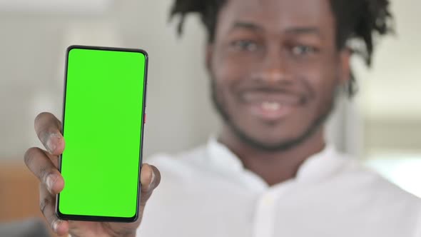 Portrait of African Man Holding Smartphone with Chroma Key Screen 