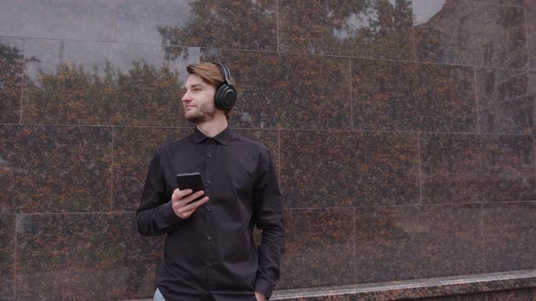 Handsome Man in Headphones Listening to Music