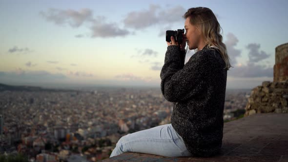 Portrait of female photographer with city in background