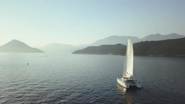 Aerial view of Yacht cruising on the sea or ocean in summer day in Montenegro.