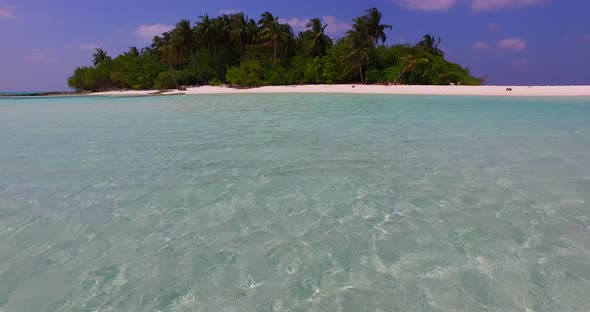 Wide angle flying copy space shot of a white paradise beach and aqua turquoise water background in v