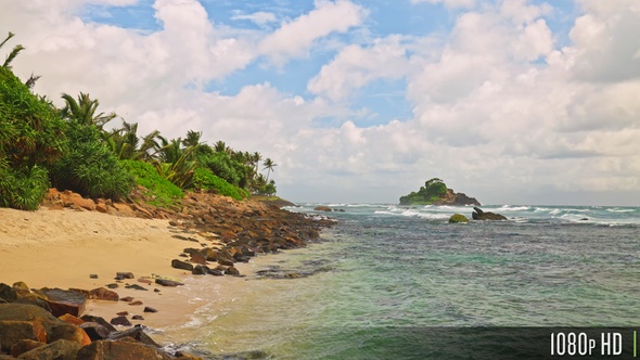 Empty tropical beach coast with partly cloudy skies in slow motion, Sri Lanka