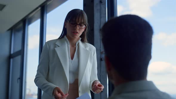 Woman Assisting Company Ceo at Panorama Window