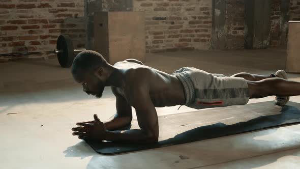 Sport man doing plank exercise, fitness workout at gym