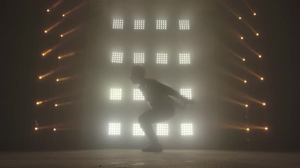 Breakdance Concept. Trendy Young Man Dancing Single in Club, Neon Light, Lots of Smoke. Fashion