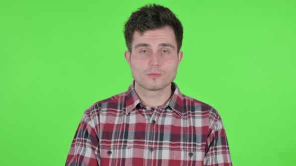 Portrait of Young Man Talking on Online Video Call Green Chroma Screen