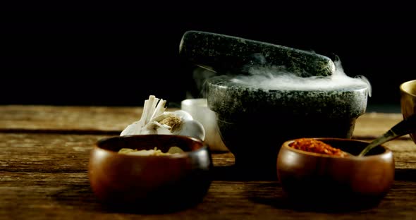 Various type of spices in bowl with mortar and pestle 4k