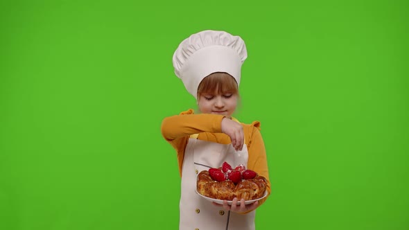 Child Girl Kid Dressed As Cook Chef Sprinkle Strawberry Pie with Icing Sugar Chroma Key Background