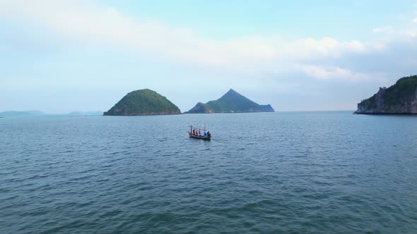 A fisherman is sailing in the sea among the islands near the coast.