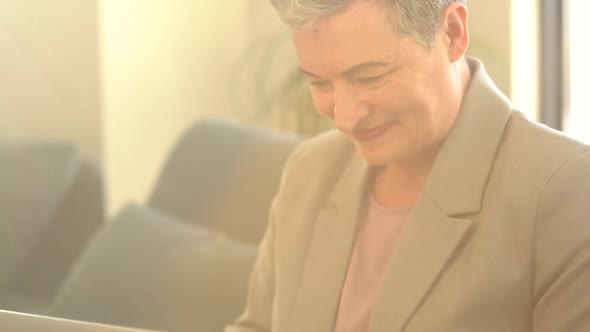 Close Portrait of Grayhaired Woman with Short Haircut Indoor