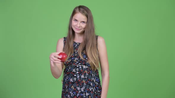 Young Beautiful Pregnant Woman Throwing Apple in the Air