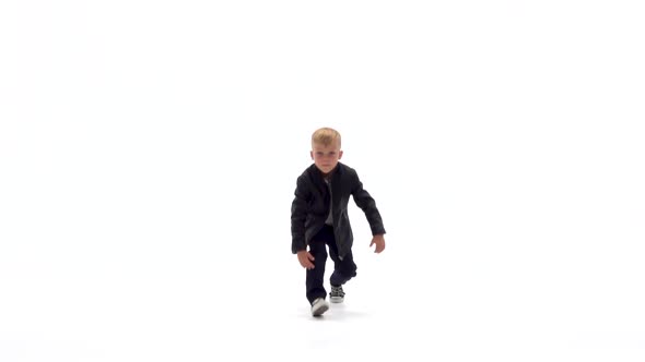 Little Boy Is Dancing a Modern Dance on the White Background in Black Leather Jackets and Jeans