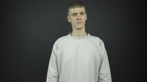 Thin Blue Eyed Guy in Grey Pullover Poses for Photo Shoot